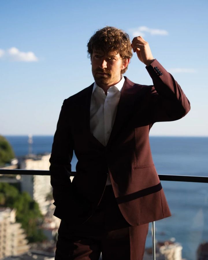 Simon, founder of agape, on a balcony above the sea
